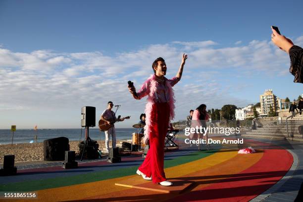 People take photos as a Harry Styles wax figure is unveiled on Coogee Beach on July 18, 2023 in Sydney, Australia.