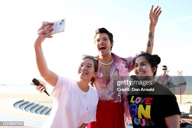 People take selfies as a Harry Styles wax figure is unveiled on Coogee Beach on July 18, 2023 in Sydney, Australia.