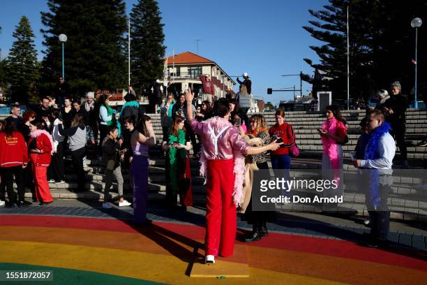 People take photos as a Harry Styles wax figure is unveiled on Coogee Beach on July 18, 2023 in Sydney, Australia.