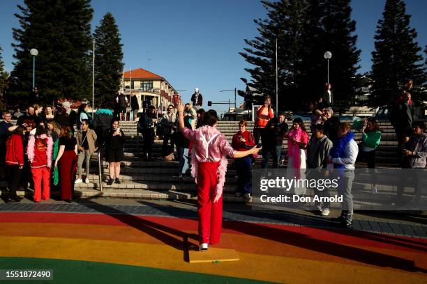 People take photos as a Harry Styles wax figure is unveiled on Coogee Beach on July 18, 2023 in Sydney, Australia.