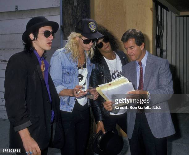 Musicians Izzy Stradlin, Duff McKagan and Slash of Guns N Roses and Dick Clark attend 47th Annual Golden Globe Awards on January 20, 1990 at the...