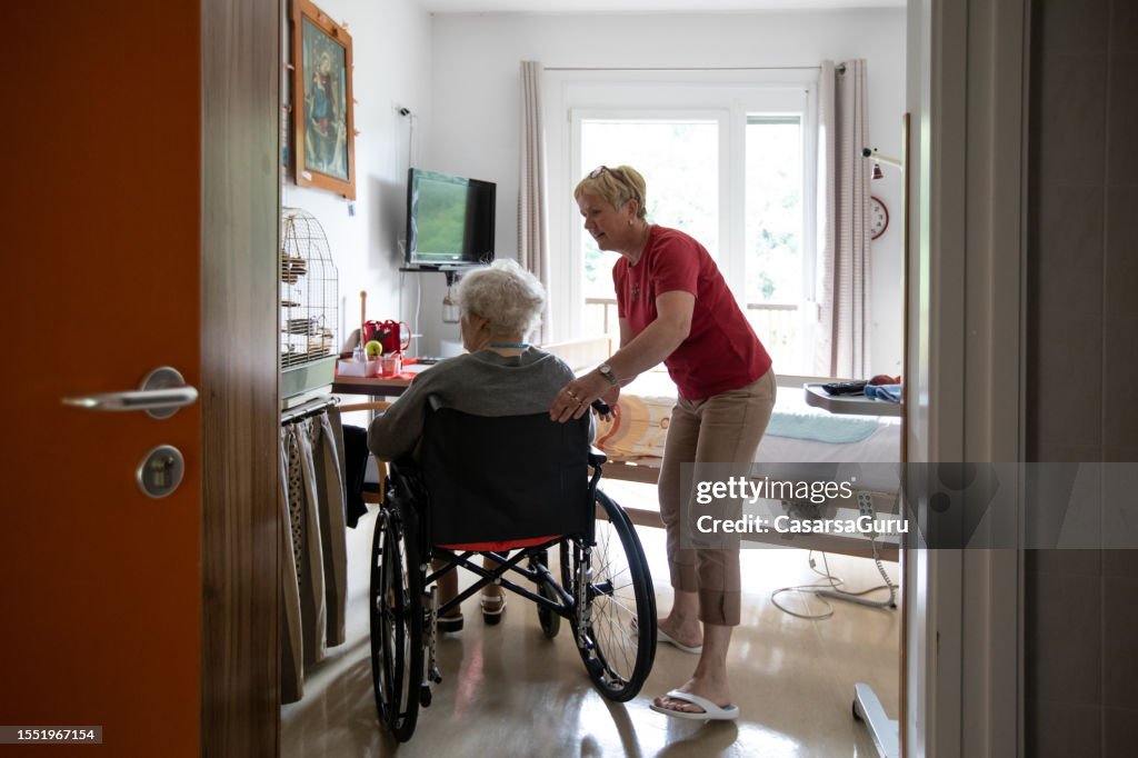Caregiver and a senior woman in a wheelchair