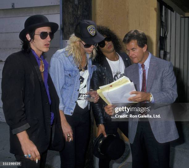 Musicians Izzy Stradlin, Duff McKagan and Slash of Guns N Roses and Dick Clark attend 47th Annual Golden Globe Awards on January 20, 1990 at the...