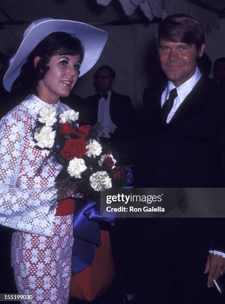 Musician Glen Campbell and Billie Jean Nunley attend Honor America Day on July 4, 1970 in Washington, D.C.