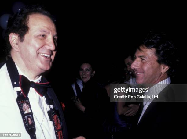Ron Galella and actor Dustin Hoffman attend "Smile" Party on November 24, 1986 at Club 4D in New York City.