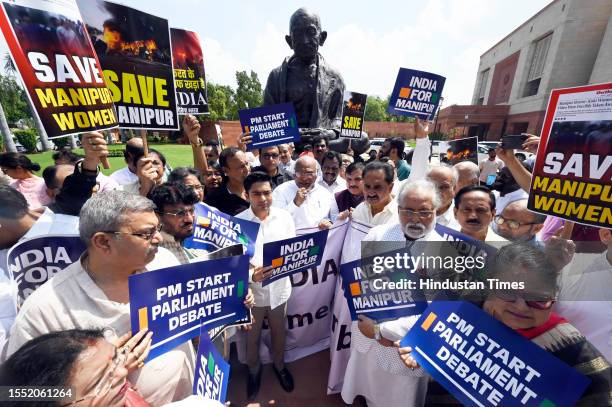Opposition parties alliance MPs including Mallikarjun Kharge, and others protest at the premises of Parliament, demanding PM Modi's statement on...