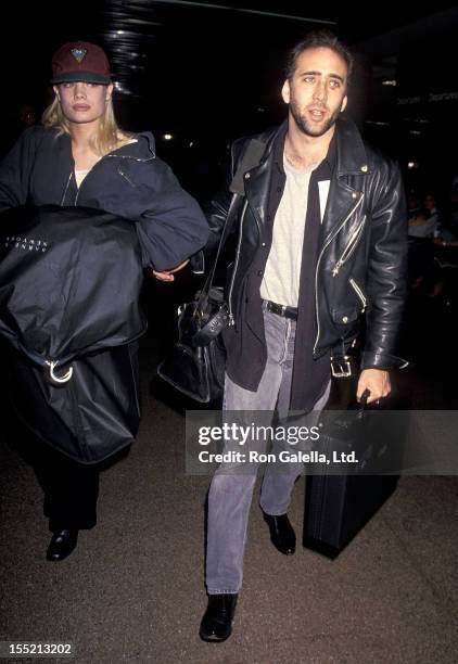 Actor Nicolas Cage and girlfriend Kristen Zang depart for New York City on January 2, 1994 at Los Angeles International Airport in Los Angeles,...