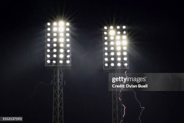 Lightning strikes behind the stadiums lights during a weather delay of the game between the San Francisco Giants and the Cincinnati Reds at Great...