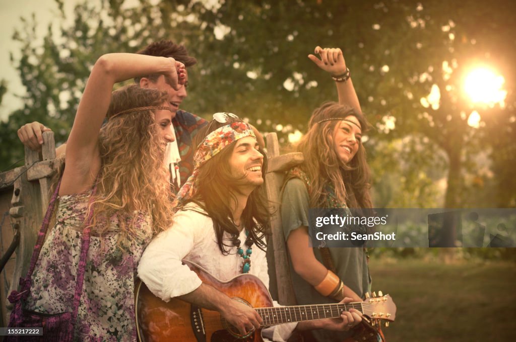 Hippies Dancing and Playing Guitar . 1970s style.