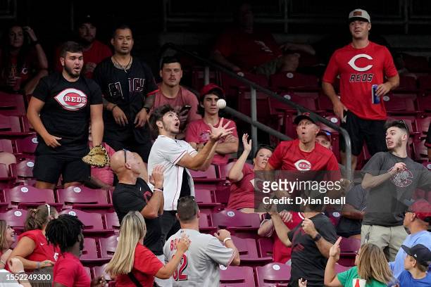 Fan catches a home run hut by Wilmer Flores of the San Francisco Giants in the sixth inning against the Cincinnati Reds at Great American Ball Park...