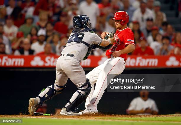 Jose Trevino of the New York Yankees makes the tag out against Hunter Renfroe of the Los Angeles Angels in the fifth inning at Angel Stadium of...