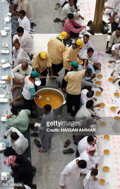 Muslim workers wait to break their fast on the first Friday of Ramadan at the Imam Turki bin Abdullah mosque in Riyadh, 14 September 2007. The...