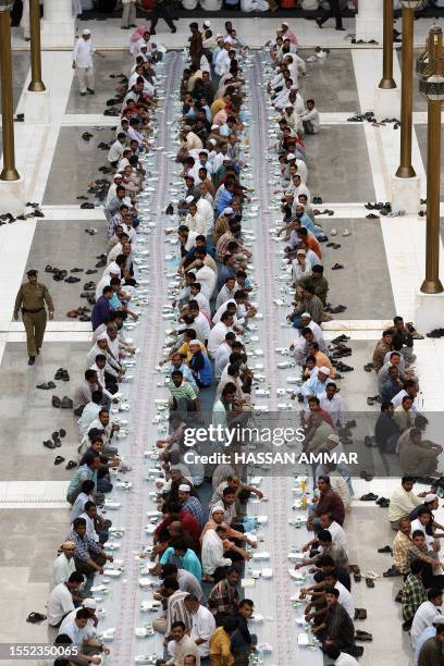 Muslim workers wait to break their fast on the first Friday of Ramadan at the Imam Turki bin Abdullah mosque in Riyadh, 14 September 2007. The...