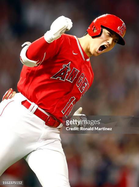 Shohei Ohtani of the Los Angeles Angels reacts after hitting a two-run home run against the New York Yankees in the seventh inning at Angel Stadium...