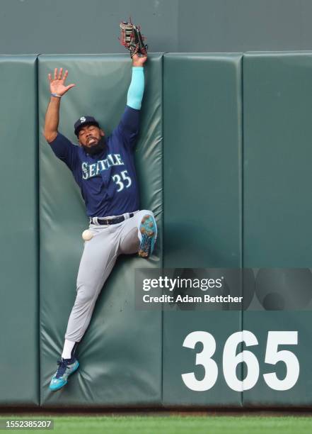 Teoscar Hernandez of the Seattle Mariners misses the catch on a Trevor Larnach of the Minnesota Twins triple in the fifth inning at Target Field on...