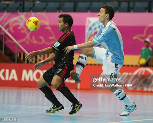 Maximiliano Rescia of Argentina tries to tackle Jorge Rodriguez of Mexico during the FIFA Futsal World Cup Thailand 2012, Group D match between...