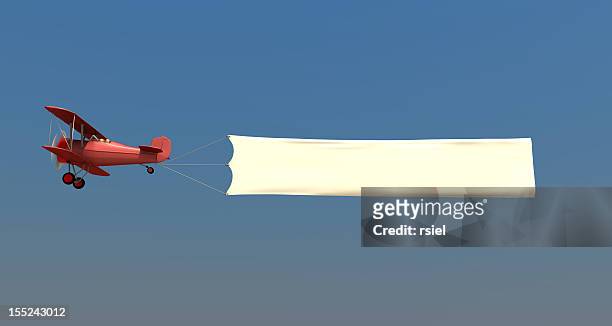 airplane towing a banner - commercial aircraft flying stockfoto's en -beelden