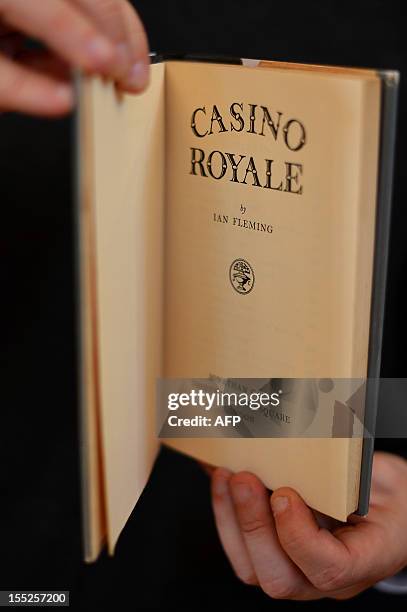 Book dealer Jon Gilbert poses with a first edition copy of Ian Fleming's James Bond book 'Casino Royal' valued at 30,000 GBP during the Chelsea...