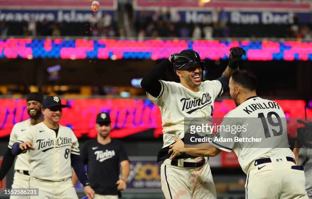 Carlos Correa and Alex Kirilloff of the Minnesota Twins celebrate Correas walk off RBI against the Seattle Mariners in the tenth inning at Target...