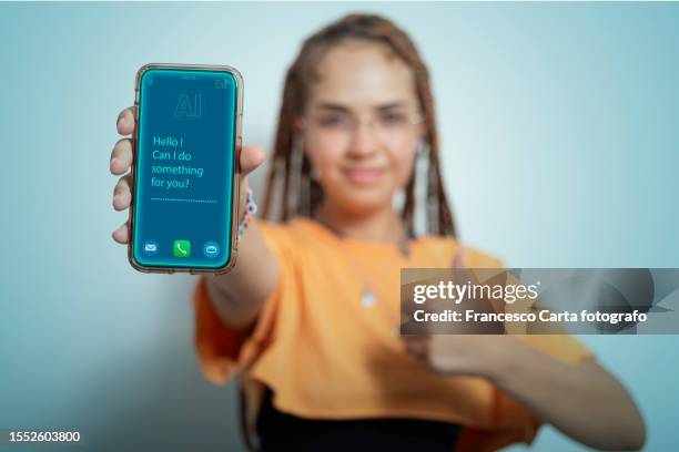 woman shows her smartphone with the chatbot interface - customer experience stock pictures, royalty-free photos & images