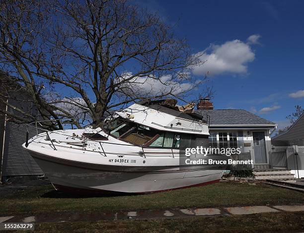 In the aftermath of Hurricane Sandy, boats continue to litter the landscape on Grant Street on November 2, 2012 in Freeport, New York. With the death...