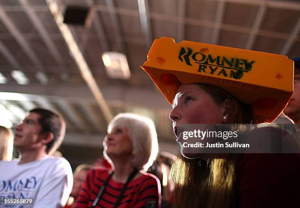 Supporter wears a Cheesehead hat as Republican presidential candidate, former Massachusetts Gov. Mitt Romney speaks during a campaign rally at the...