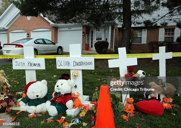 Four wooden crosses mark the house at the scene of the double homicide of two children, five-year-old Olivia Dworakowski and seven-year-old Justin...