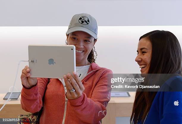 Shannon Harman tests out the new iPad mini before purchasing one as an Apple employee watches on November 2, 2012 in Los Angeles, California. It was...