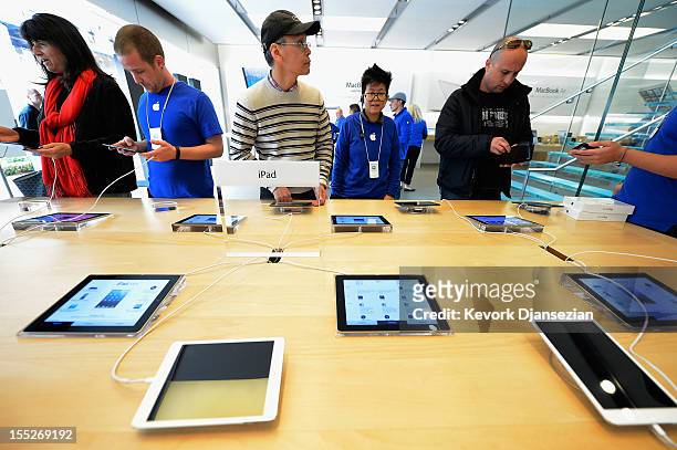Customers test out the new iPad minis on display at the Apple Store on November 2, 2012 in Los Angeles, California. It was reported that lines at...