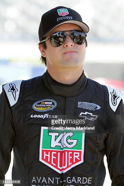 Nelson Piquet Jr., driver of the TAG Heuer Avant-Garde Eyewear Chevrolet, stands on the grid during qualifying for the NASCAR Camping World Truck...