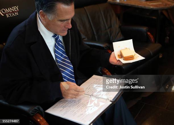 Republican presidential candidate, former Massachusetts Gov. Mitt Romney eats a peanut butter and honey sandwich while looking over notes aboard his...
