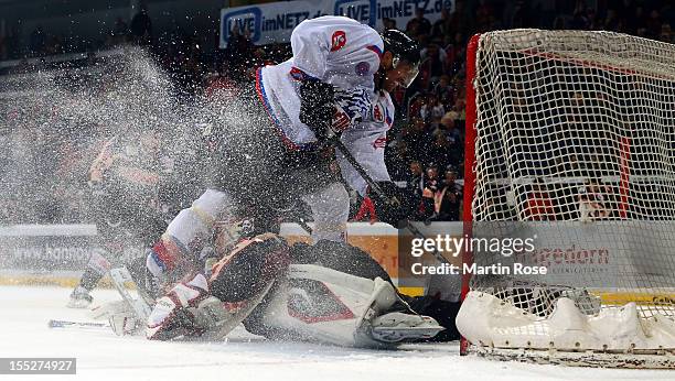 Dimitri Paetzold , goaltender of Hannover stops Steven Rupprich of Nuernberg in front of the net during the DEL match between Hannover Scorpions and...