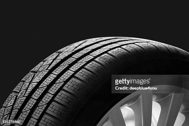 car tire on dark backgroound - continental stock pictures, royalty-free photos & images