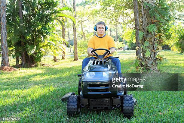 man on riding mower - lawn tractor stock pictures, royalty-free photos & images