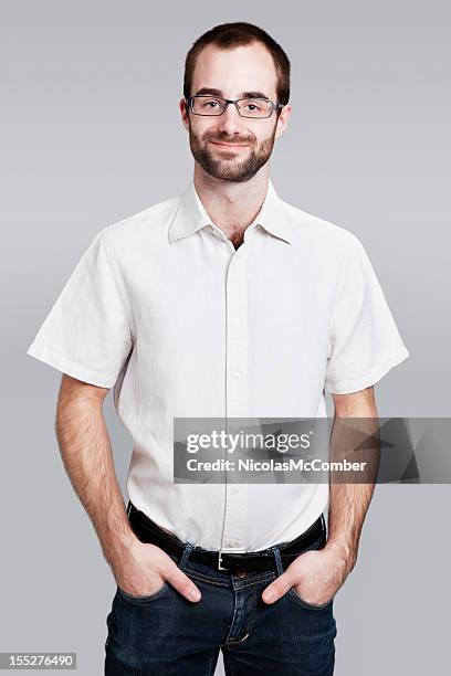 contemporary worker with hands in pockets - short sleeved stockfoto's en -beelden