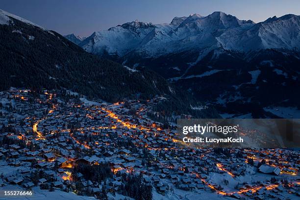 panoramic view of m. gele and verbier village by night - alpine chalet stock pictures, royalty-free photos & images