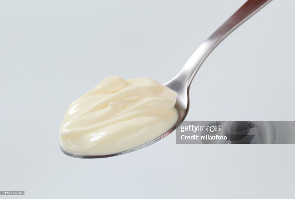 A teaspoon with a dollop of thick cream on it
