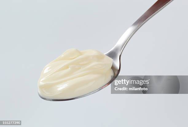 a teaspoon with a dollop of thick cream on it - spoon stock pictures, royalty-free photos & images