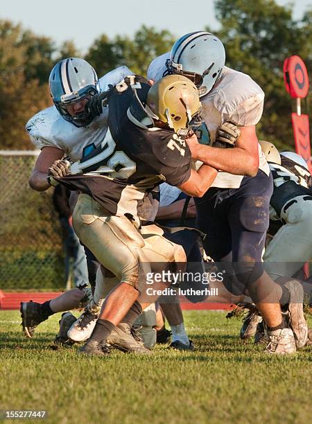 football players blocking an opponent - tackling stock pictures, royalty-free photos & images