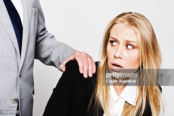 young businesswoman pulls away from unwelcome touch by mature businessman - rea001 stock pictures, royalty-free photos & images