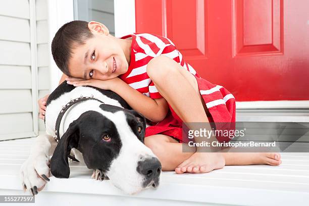 young boy bonding with his dog - great dane home stock pictures, royalty-free photos & images