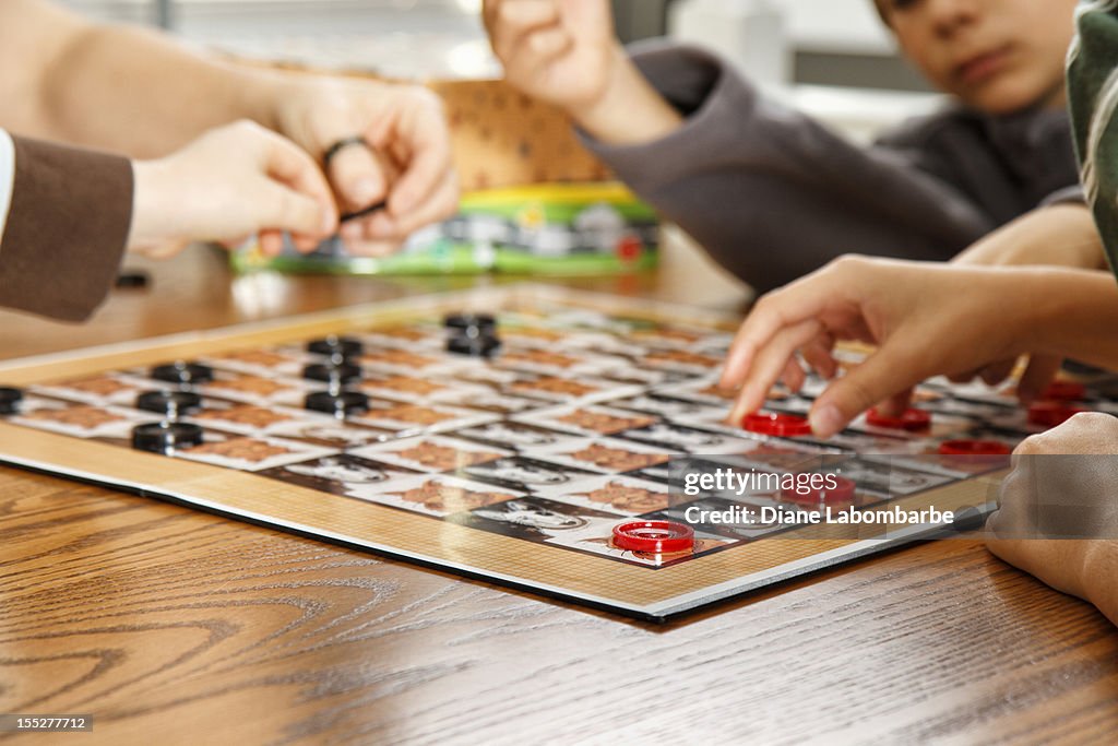 Family Playing A Board Game Together