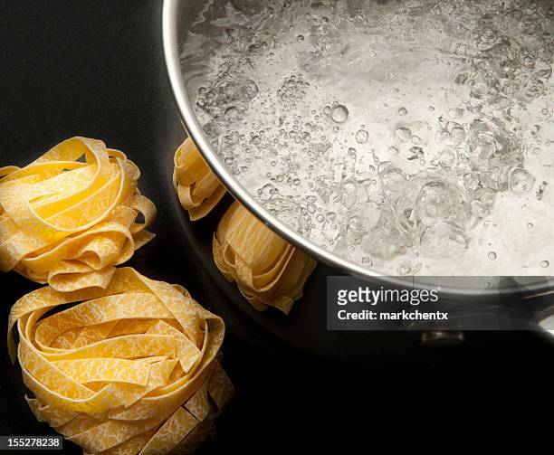 cooking tagliatelle - boiling pasta stock pictures, royalty-free photos & images