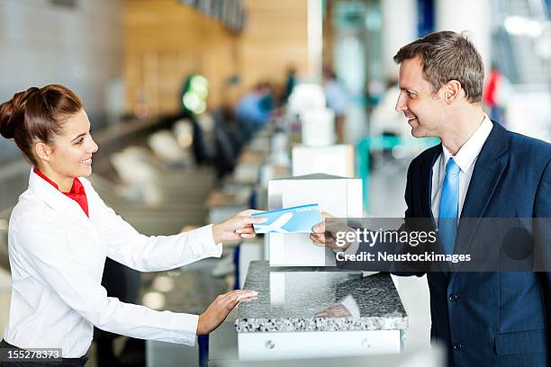 businessman checking in at the airport - travel agent stock pictures, royalty-free photos & images