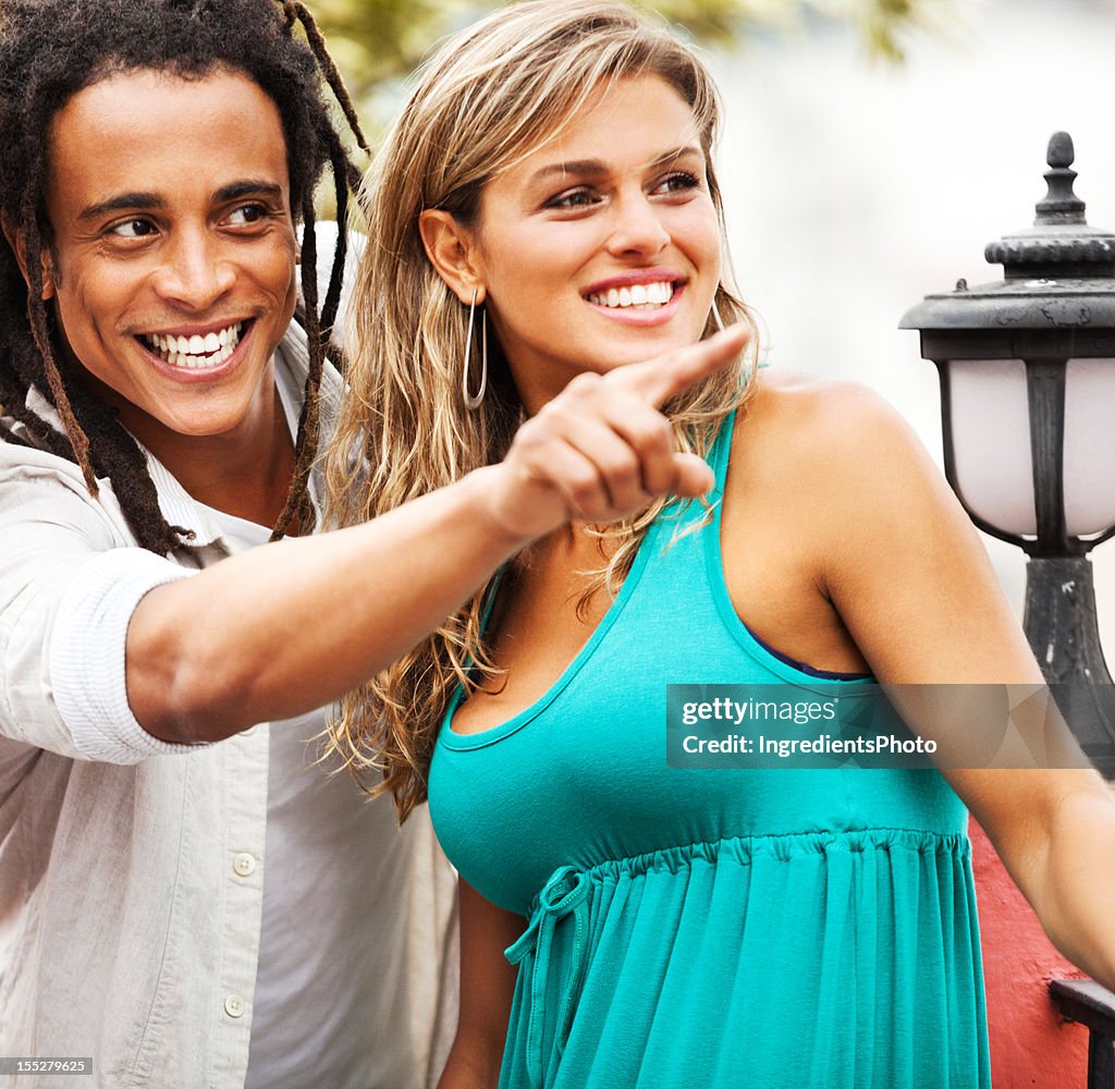 Young beautiful brazilian couple enjoying each other's company on balcony.