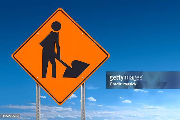 construction worker road sign post on blue sky clipping path - construction sign stock pictures, royalty-free photos & images