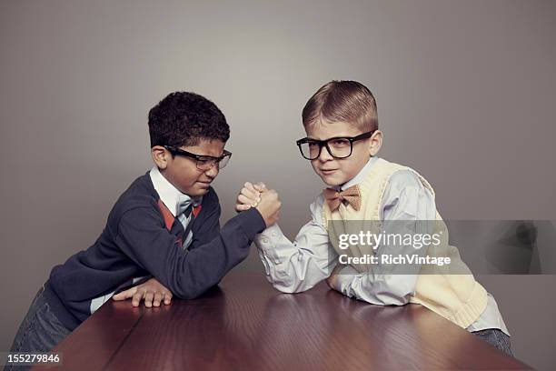 scholarly competition - arm wrestle stock pictures, royalty-free photos & images