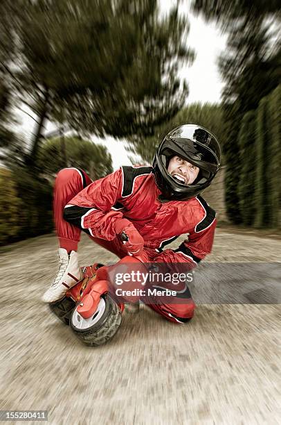 middle-aged man on red children's bike on blurry background - moto humour stock pictures, royalty-free photos & images