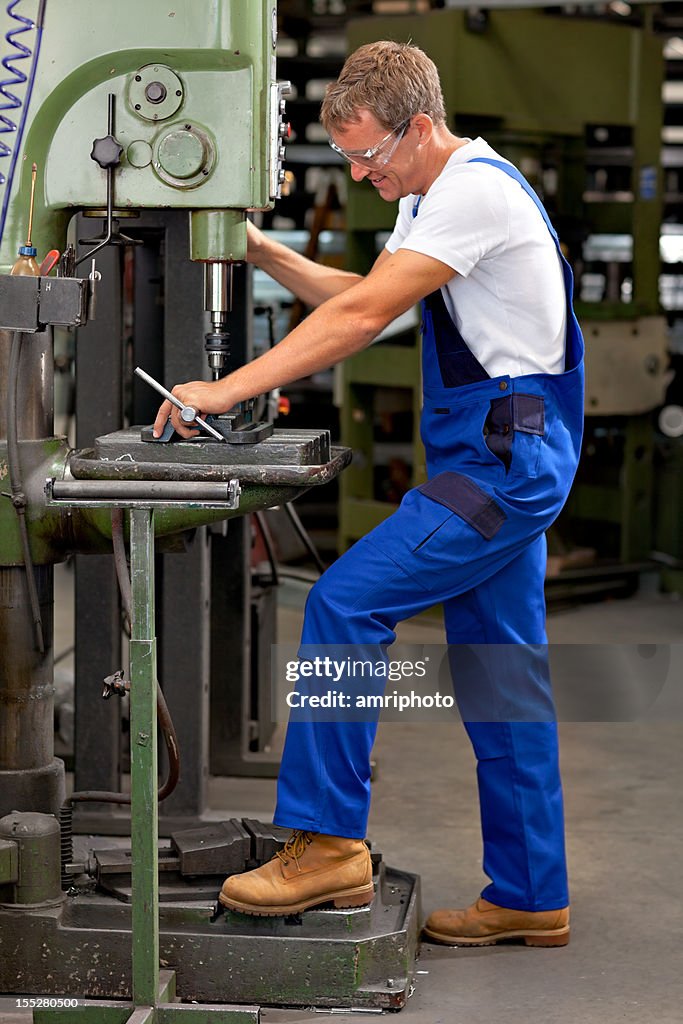 Busy craftsman at drill machine