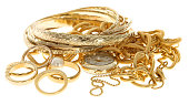 A pile of scrap gold jewelry on a white background